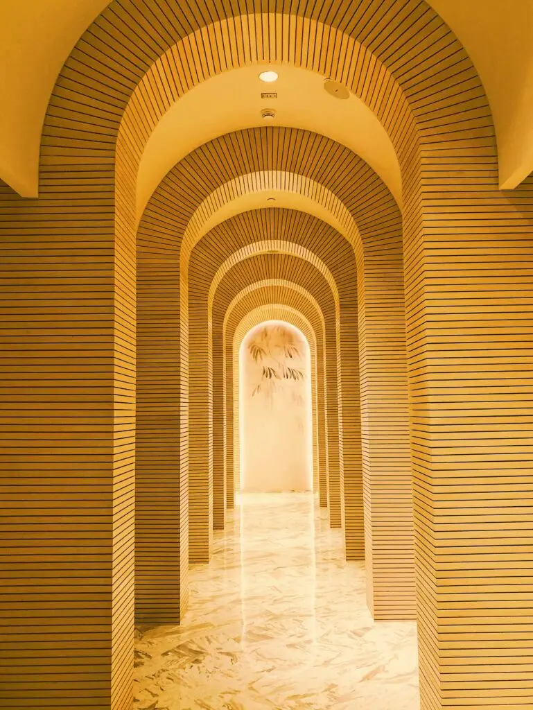 Exquisite interior of an arched corridor in a Dubai palace with gold tones.